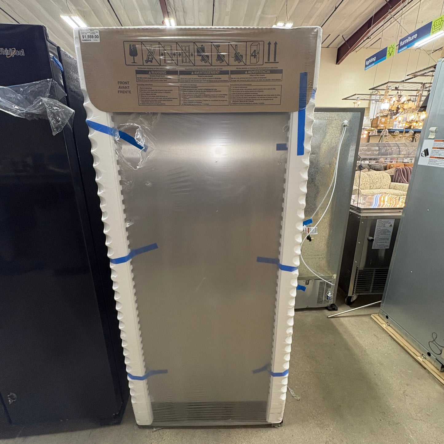GDM Habitat for Humanity ReStore Whirlpool 18 cu. ft. upright freezer in stainless steel, wrapped in protective film.