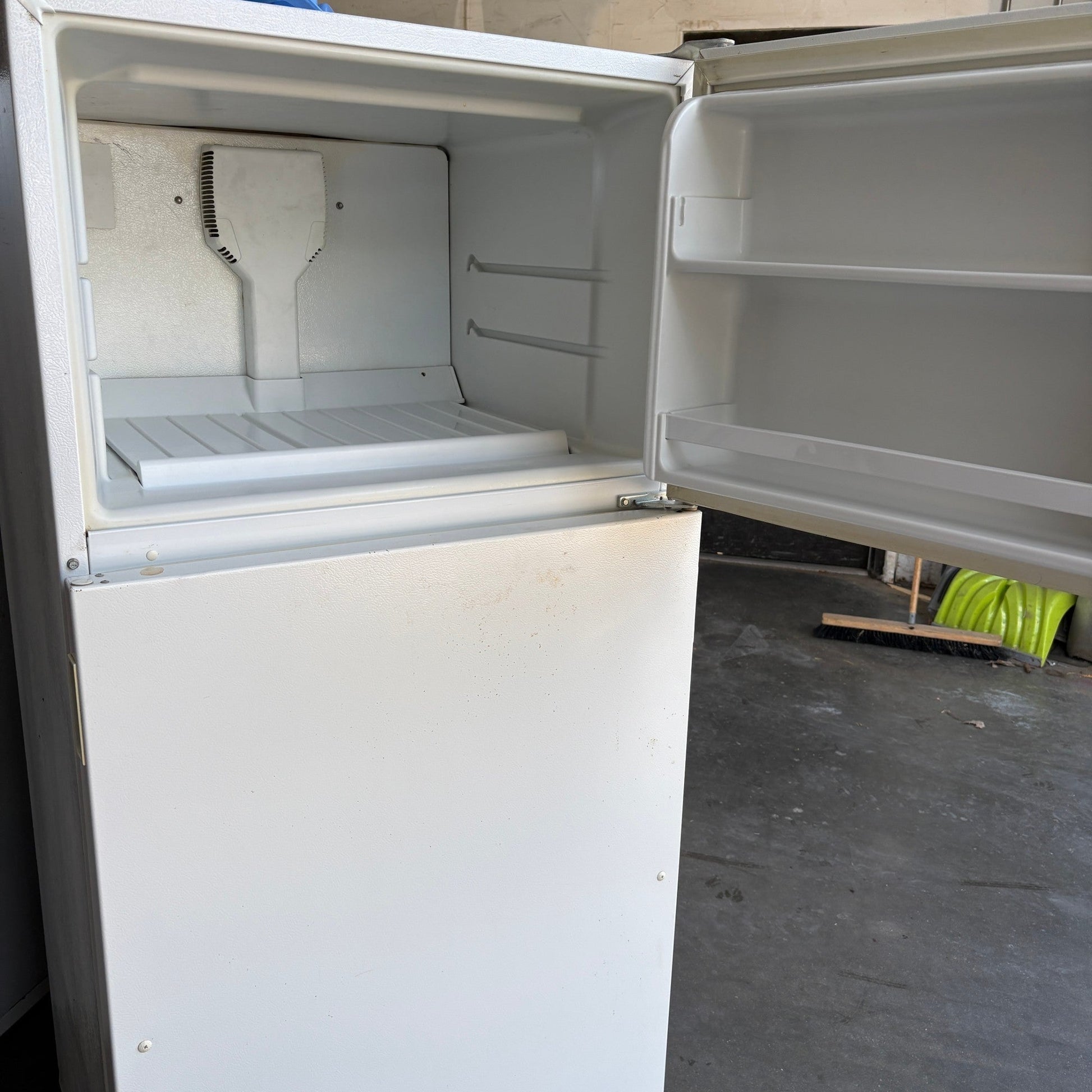 GDM Habitat for Humanity ReStore white Whirlpool top-freezer refrigerator with open freezer door