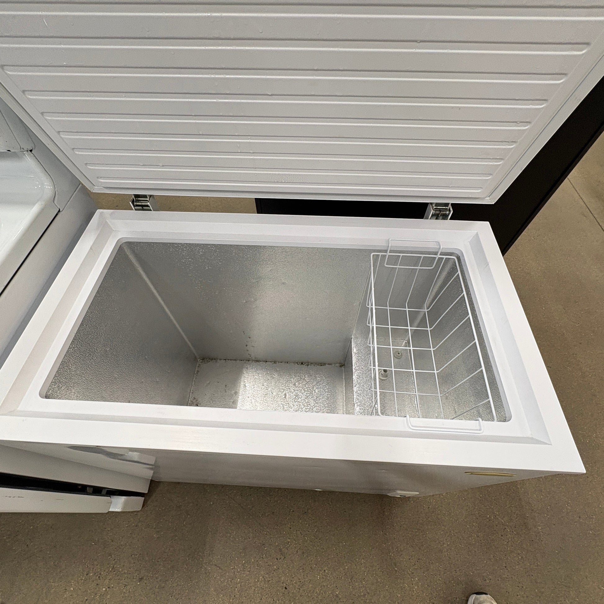 GDM Habitat for Humanity ReStore white chest freezer with open lid and interior storage basket