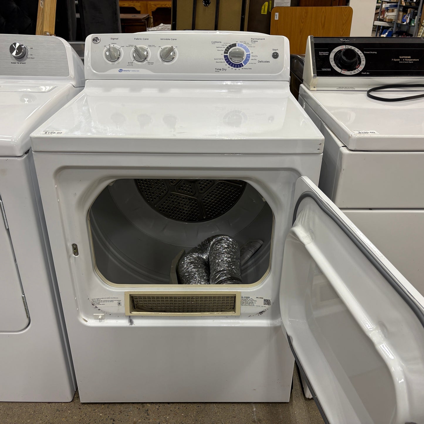 GDM Habitat for Humanity ReStore white GE electric clothes dryer with open door and internal vent hose