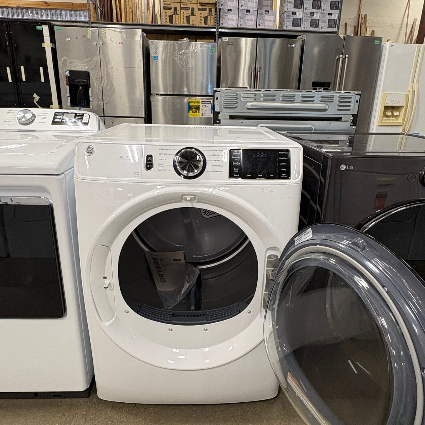 GDM Habitat for Humanity ReStore white GE front load electric dryer with open door in a retail showroom
