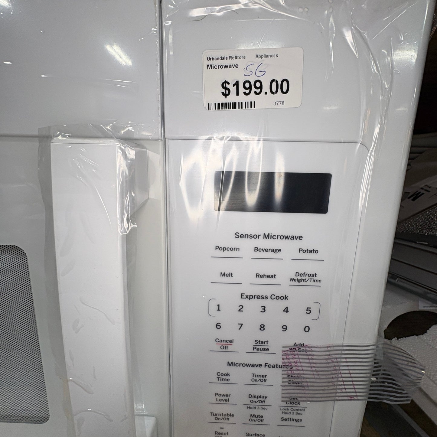 GDM Habitat for Humanity ReStore white GE over-the-range microwave oven with sensor cooking control panel