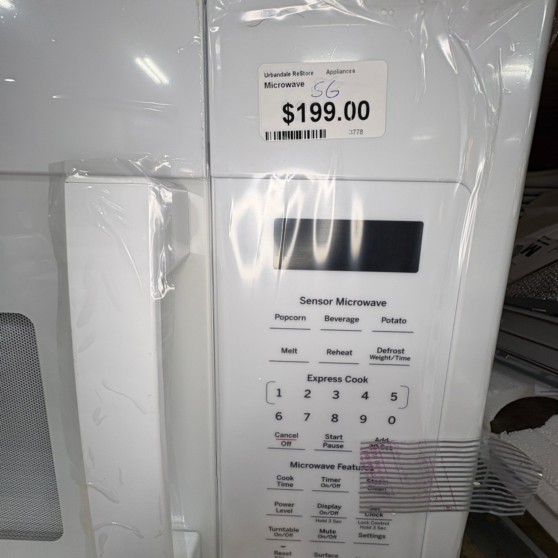 GDM Habitat for Humanity ReStore white GE over-the-range microwave oven with sensor cooking control panel