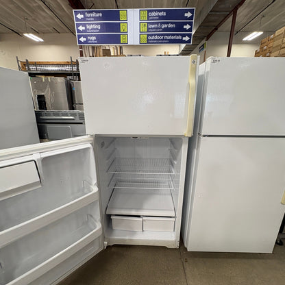 GDM Habitat for Humanity ReStore white GE top-freezer refrigerator with open door and wire shelves in a retail store