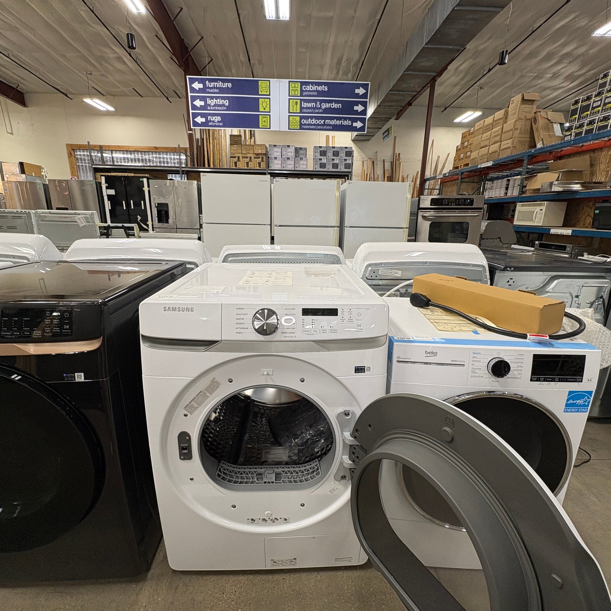GDM Habitat for Humanity ReStore white Samsung front load washing machine with open door in a retail showroom